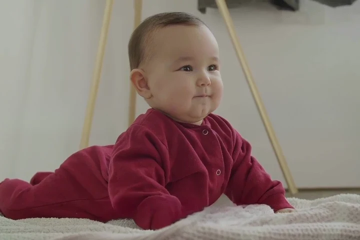 A baby looking attentively at someone nearby
